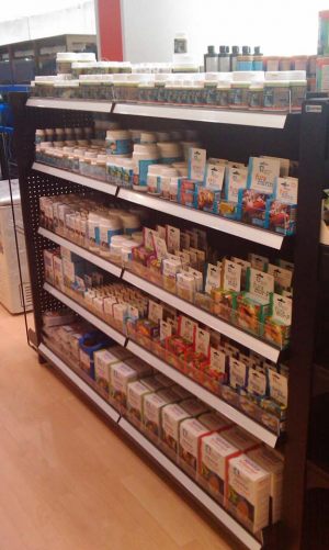 An island gondola shelving neatly stocked with health care products.